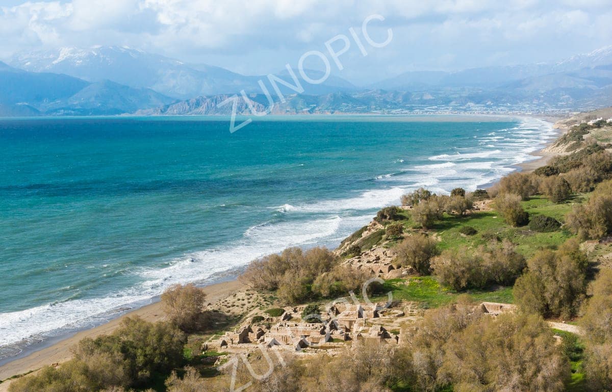 Turquoise sea and a long sandy coastline beside ancient ruins