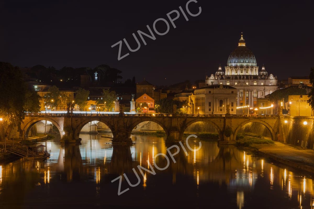 St Peter's Basilica and a river bridge lit up at night