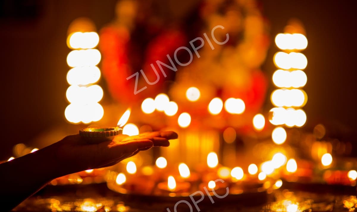 Lighting rows of diyas during Diwali
