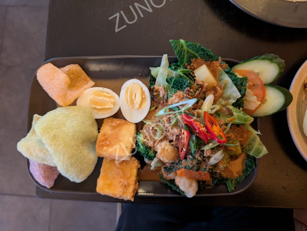 Gado-gado salad with egg, tofu and crackers, top view