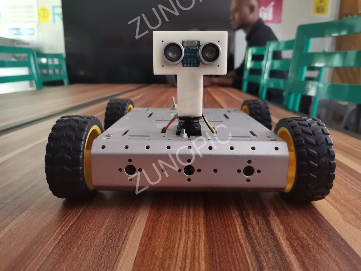 Small obstacle-avoiding robot car on a wooden table